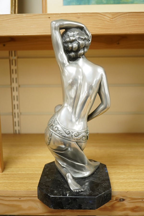 An Art Deco style figure of semi nude woman, raised on shaped marble base, in the style of Giuseppe Bessi, 37cm high. Condition - good